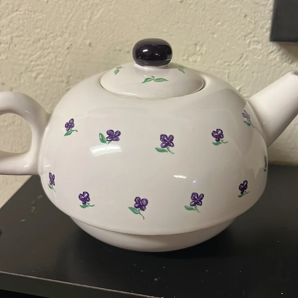 Small white teapot with violet and bee details.